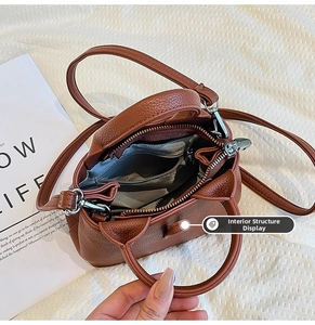 Detail view of the brown lychee pattern leather handbag interior showing multi-compartments