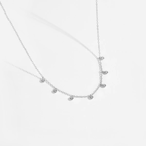 Macro shot of 925 silver necklace with seven round-cut cubic zirconia pendants