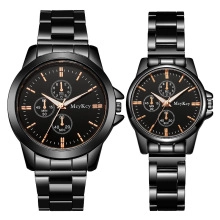 Detail of couple quartz watches with black mesh band and rose gold accents