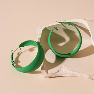 Minimalist green matte geometric C-shaped hoop earrings on elegant white stone display