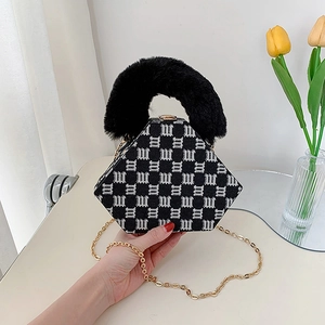 Chic black and white jacquard hexagonal handbag with black faux fur handle and gold chain