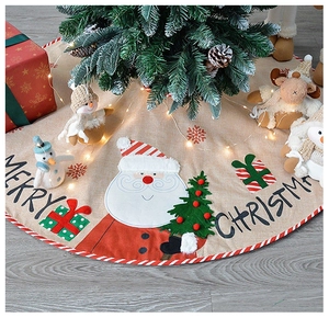 Detail of Christmas tree skirt featuring Santa and snowman patterns with Merry Christmas text