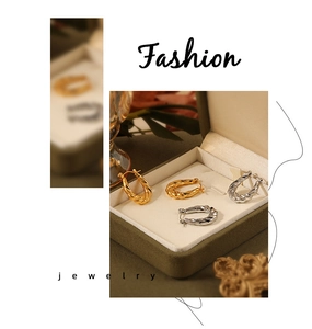 Detail of twisted rope design C-shape hoop earrings in gold and silver finish