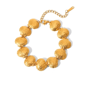 Detail of 18k gold plated shell link bracelet featuring textured scallop charms and clasp