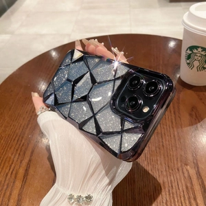 Close-up of deep blue diamond-cut phone case with silver glitter effect on a cafe table
