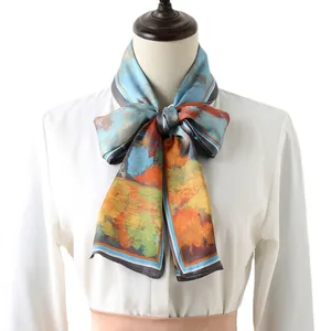 Impressionist floral long silk scarf tied as a bow on a white shirt collar