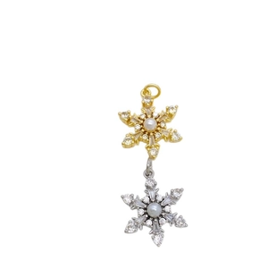 Gold and silver snowflake charm pendants with centered pearls and zircon stone accents