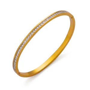 Detail shot of golden titanium steel bracelet with pavé-set sparkling crystals