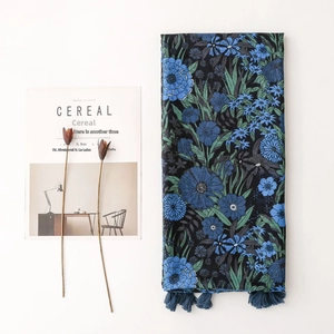 Vintage navy blue floral scarf with tassels on white background with decorative props