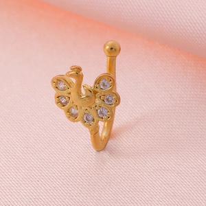 Detailed macro view of a golden peacock nose clip featuring sparkling zircon stones