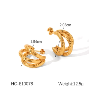 Macro view of gold multi-layer twisted hoop earrings with size measurements in centimeters