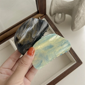 Gradient marble hair claw clips in black gold and light blue for elegant hairstyles