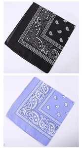 Flat lay of black and light purple paisley bandanas showing detailed pattern and texture