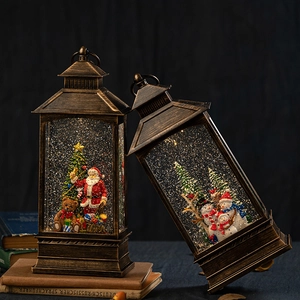 Vintage bronze Christmas lantern snow globe with Santa and snowman scene decoration