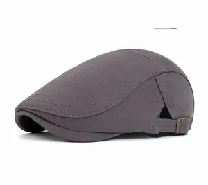 Detail of gray newsboy cap featuring side stitching and adjustable metal buckle back