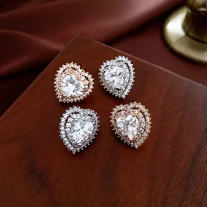 Elegant heart-shaped stud earrings with sparkling double-halo crystals in gold and silver