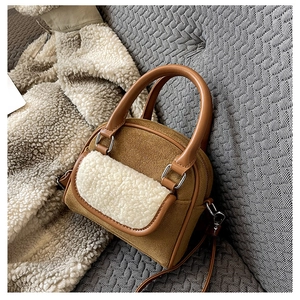 Detail of plush faux shearling trim and brown corduroy texture on the small tote bag