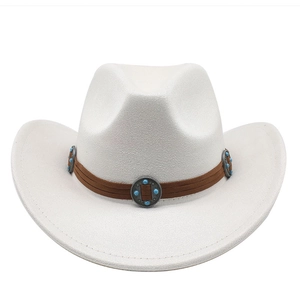 Detail of white cowboy hat featuring brown suede band with vintage turquoise metal ornaments