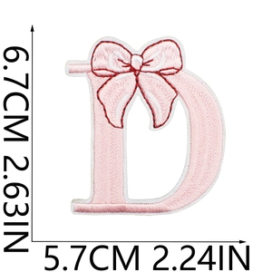 Pink embroidered letter D patch with bow detail and red border stitching, size 6.7x5.7cm