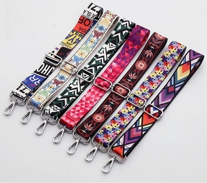 Close-up of colorful ethnic patterned shoulder straps with silver metal hooks for handbags