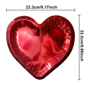 Detail of red heart-shaped paper plate with gold foil finish and textured edges for parties