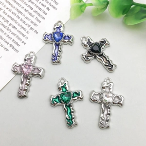 Close-up of five alloy cross pendants featuring colorful heart-shaped crystal center stones