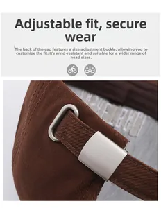 Detail of adjustable metal buckle on dark brown cotton baseball cap showing sturdy strap