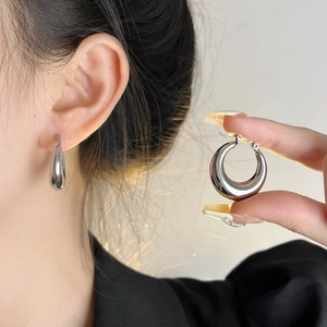 Polished silver titanium steel drop hoop earrings with glossy finish for a minimalist look