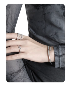 Detailed view of silver S925 open ring with hollow geometric pattern and micro-inlaid diamonds