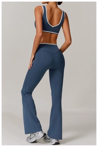 Detail of cross-back yoga top and flare leggings with contrast white piping in blue