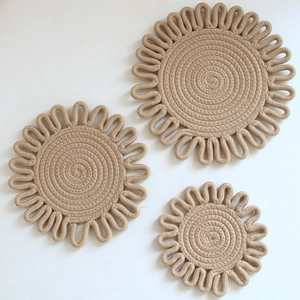Three sizes of hand-woven cotton heat-resistant flower mats in natural beige color