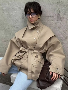 Detailed view of khaki trench coat featuring wide lapels and adjustable waist belt