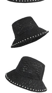 Detail of black floral lace bucket hat with elegant pearl trim on the brim edges