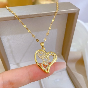 Gold-tone heart necklace with sparkling crystals and LOVE lettering in a jewelry box