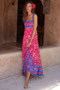 Detail of red and white spotted print dress with bright blue wavy lace trim accents