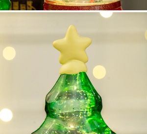 Macro shot of an LED Christmas tree decoration with green translucency and glowing stars