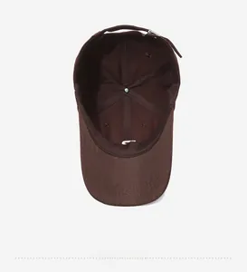 Internal view of dark brown baseball cap showing cotton twill fabric and stitching