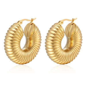 Textured gold-plated hollow hoop earrings with chunky spiral pattern on white background