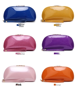 Multiple colorful sequined shell-shaped cosmetic bags with wristlet and zipper detail