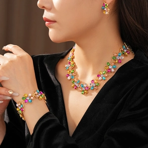 Detail shot of vintage floral jewelry set with colorful rhinestones on a female model