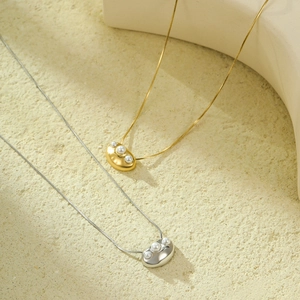 Minimalist stainless steel snake chain necklace with pearl geometric bean pendant details