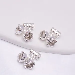 Macro detail of three 14K gold-filled lily of the valley spacer beads for DIY jewelry