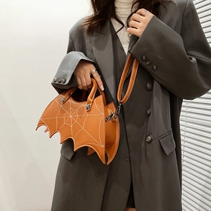 Detail showing brown bat shaped PU leather handbag with white spider web stitching pattern