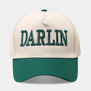 Detail of DARLIN embroidery and stitching on a two-tone canvas trucker baseball cap