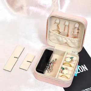 Pink portable travel jewelry box in PU leather with zipper closure and velvet lining