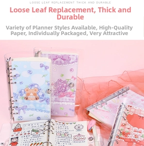 Close-up of cute cartoon loose-leaf binder notebooks with colorful illustrated inner pages