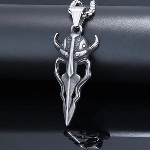Macro shot of vintage silver Viking mask pendant with horned helmet on metal chain