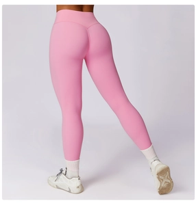 Detail view of high-waisted bright pink yoga pants featuring butt-lifting seams