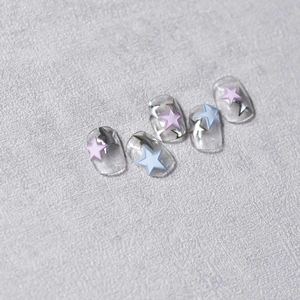 Detailed view of 5 embossed nail stickers with pink, blue, and silver stars patterns