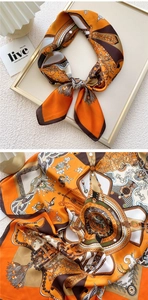 Detail of court style printed silk scarf with orange and brown chain patterns